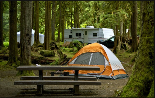 A tent and camper in a camp site. Automated campground monitoring & billing.
