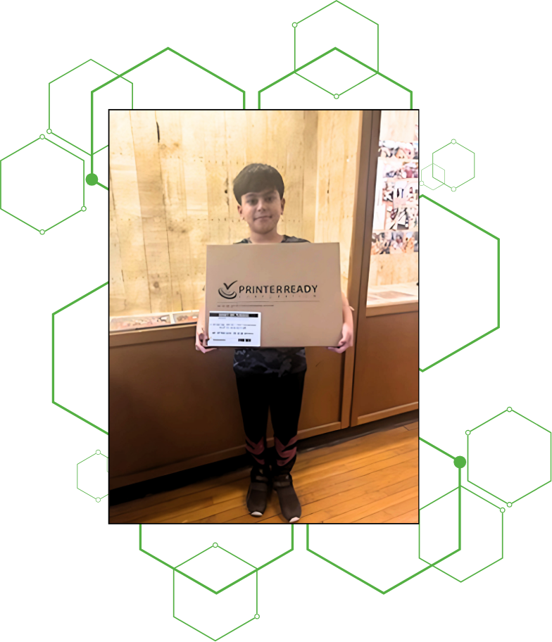 A child holding a laptop donated by ConX Wireless to Care & Share Charity.